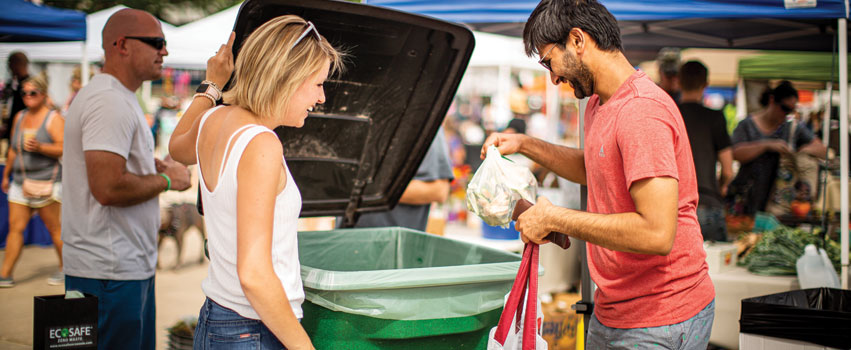 Yvonne Rosenbohm collecting compostable waste at the Peoria RiverFront Market.