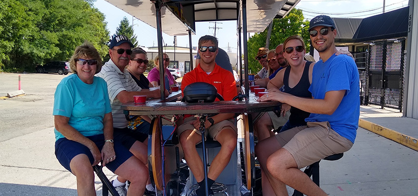 People enjoying a ride on the pedal bus.