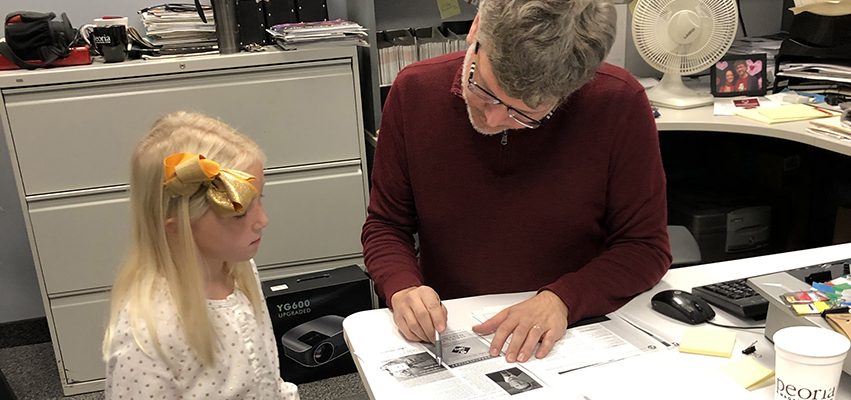 Lucy helps proof the November issue.