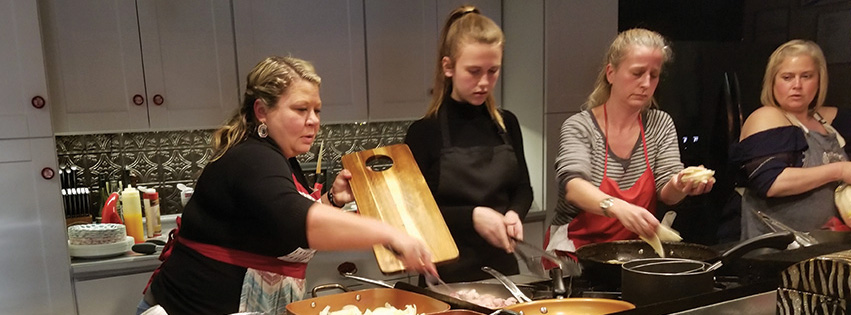 Rebecca Hearn with customers in the kitchen at Untamed Chef