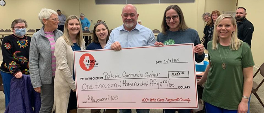 Members of 100+ People Who Care - Tazewell County present a check to the Pekin Community Center.