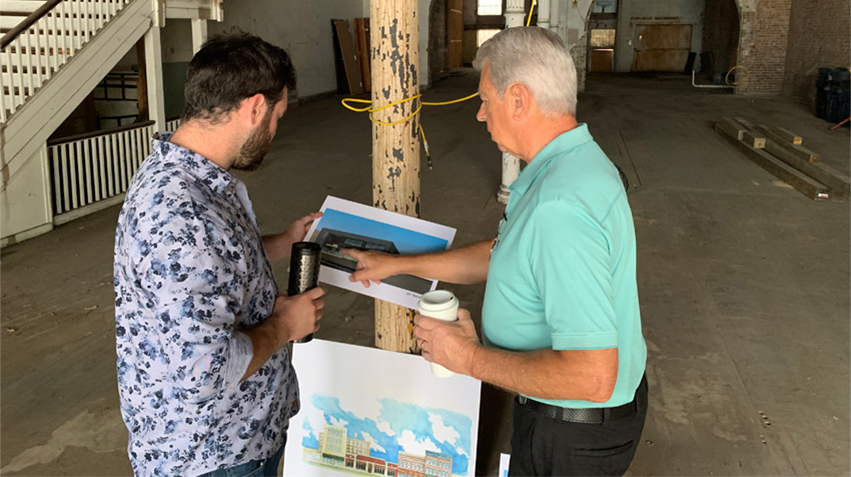 Becraft with developer Kert Huber on a building tour of Peoria's Warehouse District