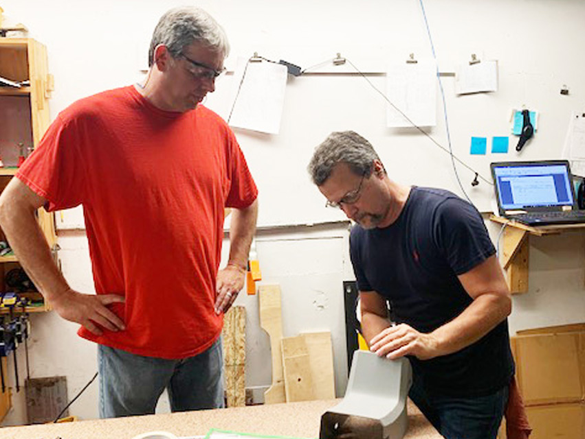 Todd Helton, quality manager, and Dave Bumbalough, final inspector, checking a part.