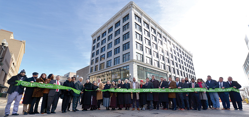 OSF HealthCare leaders cut the ribbon on the new Ministry Headquarters building in December 2021.