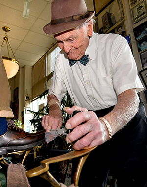 George Manias polishing shoes.