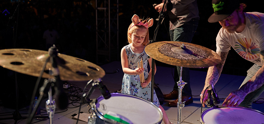 Young Girl on stage with Drums sticks