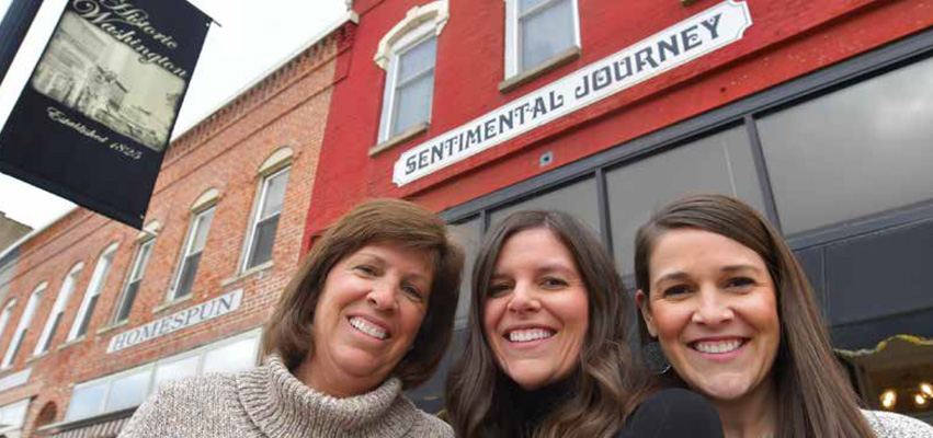 Kris Hasten with daughters Lauren Joop and Katelyn Arnold outside their store on Washington’s Square.